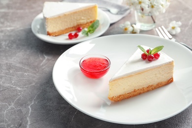 Photo of Delicious cheesecake served with sweet jam on plate