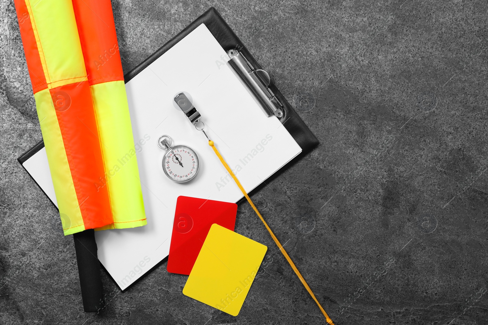 Photo of Different referee equipment on grey table, top view. Space for text