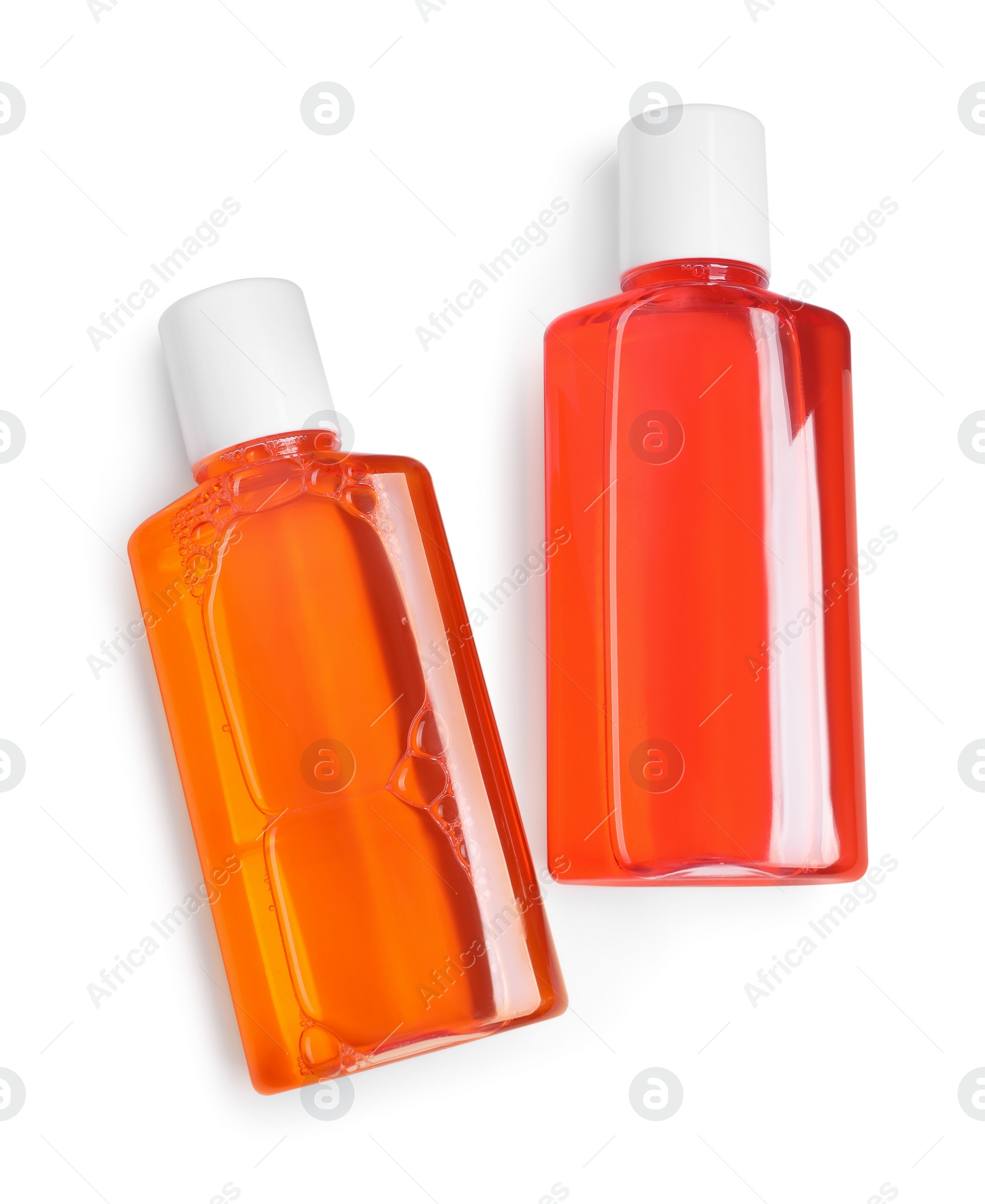 Photo of Fresh mouthwash in bottles isolated on white, top view