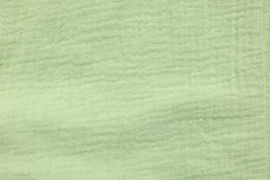 Photo of Texture of light green fabric as background, top view