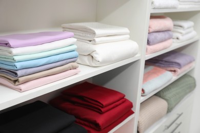 Different color linens on shelves in shop