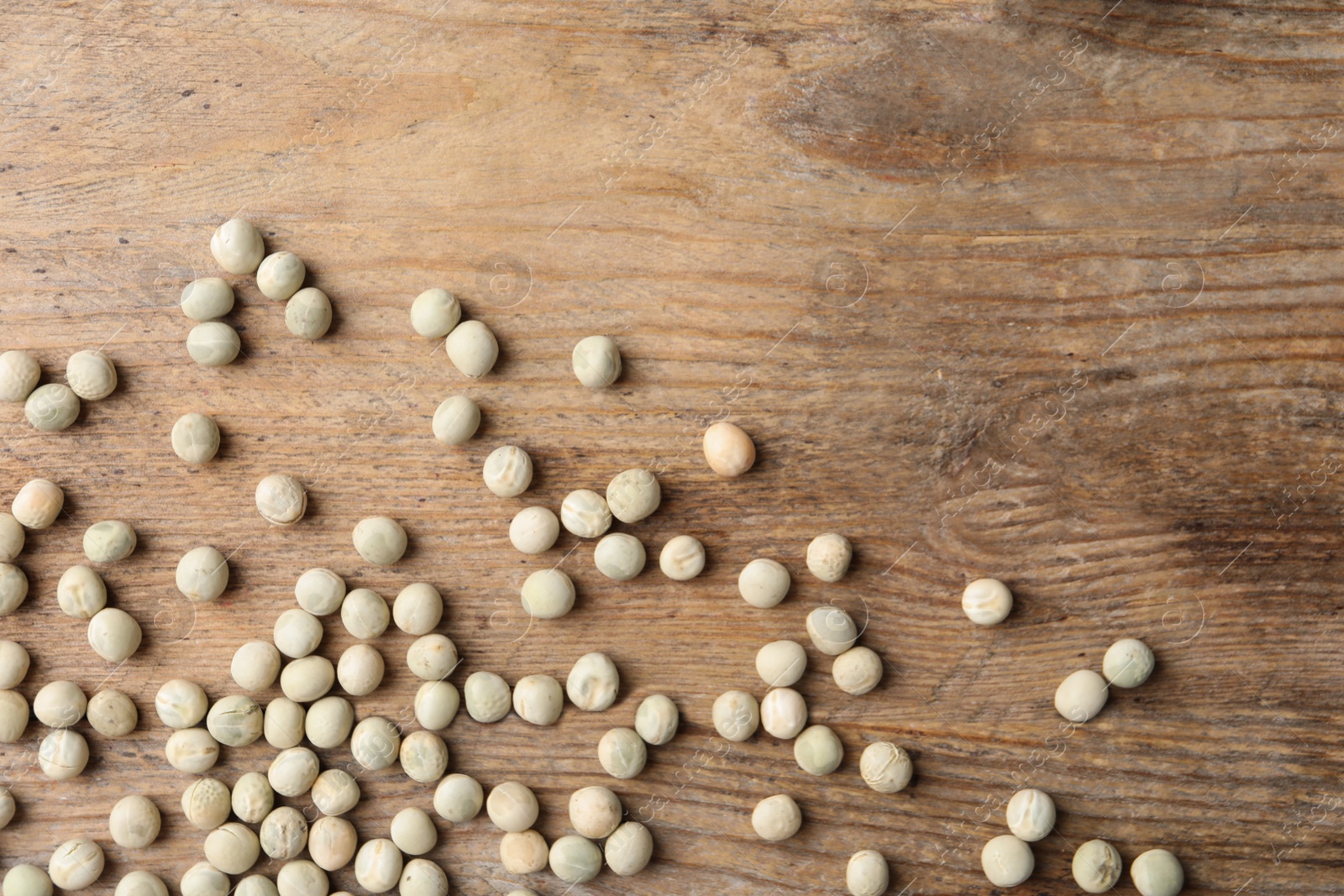 Photo of Raw dry peas on wooden background, flat lay. Vegetable seeds