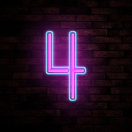 Image of Glowing neon number 4 sign on brick wall