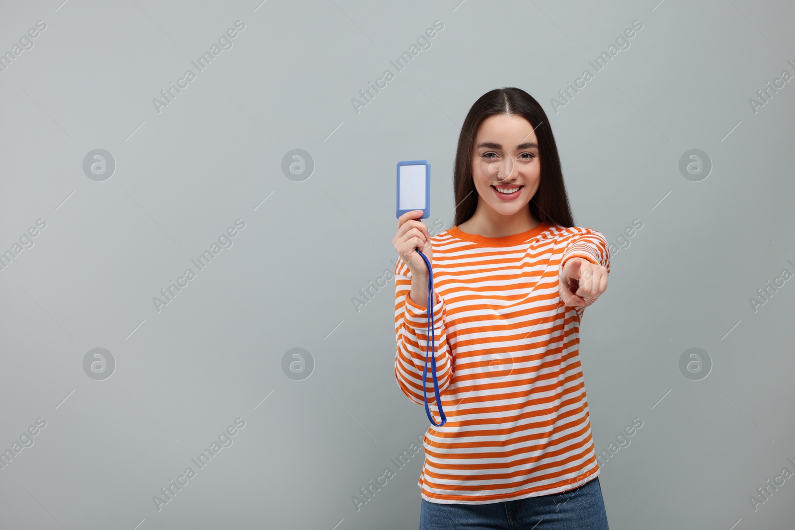 Photo of Happy woman with vip pass badge on grey background. Space for text