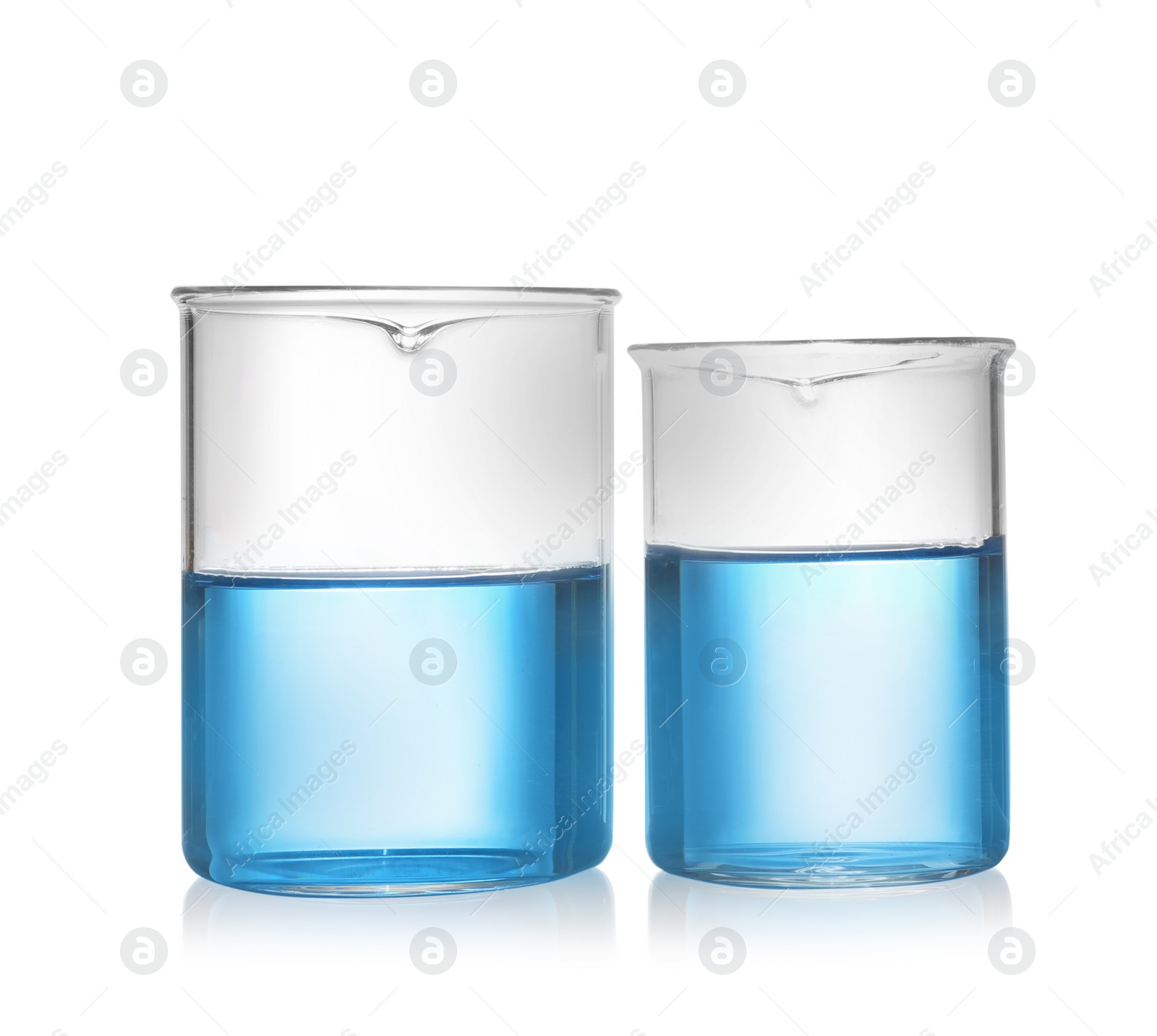 Photo of Beakers with blue liquid isolated on white. Laboratory glassware