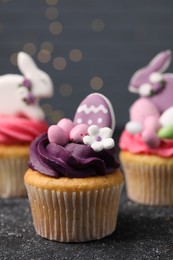 Photo of Tasty decorated Easter cupcakes on grey table