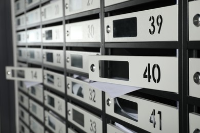 Photo of Open mailboxes with keyholes, numbers and receipts