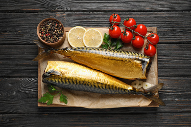 Photo of Tasty smoked fish on wooden table, top view