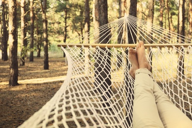 Photo of Man resting in hammock outdoors on summer day, closeup