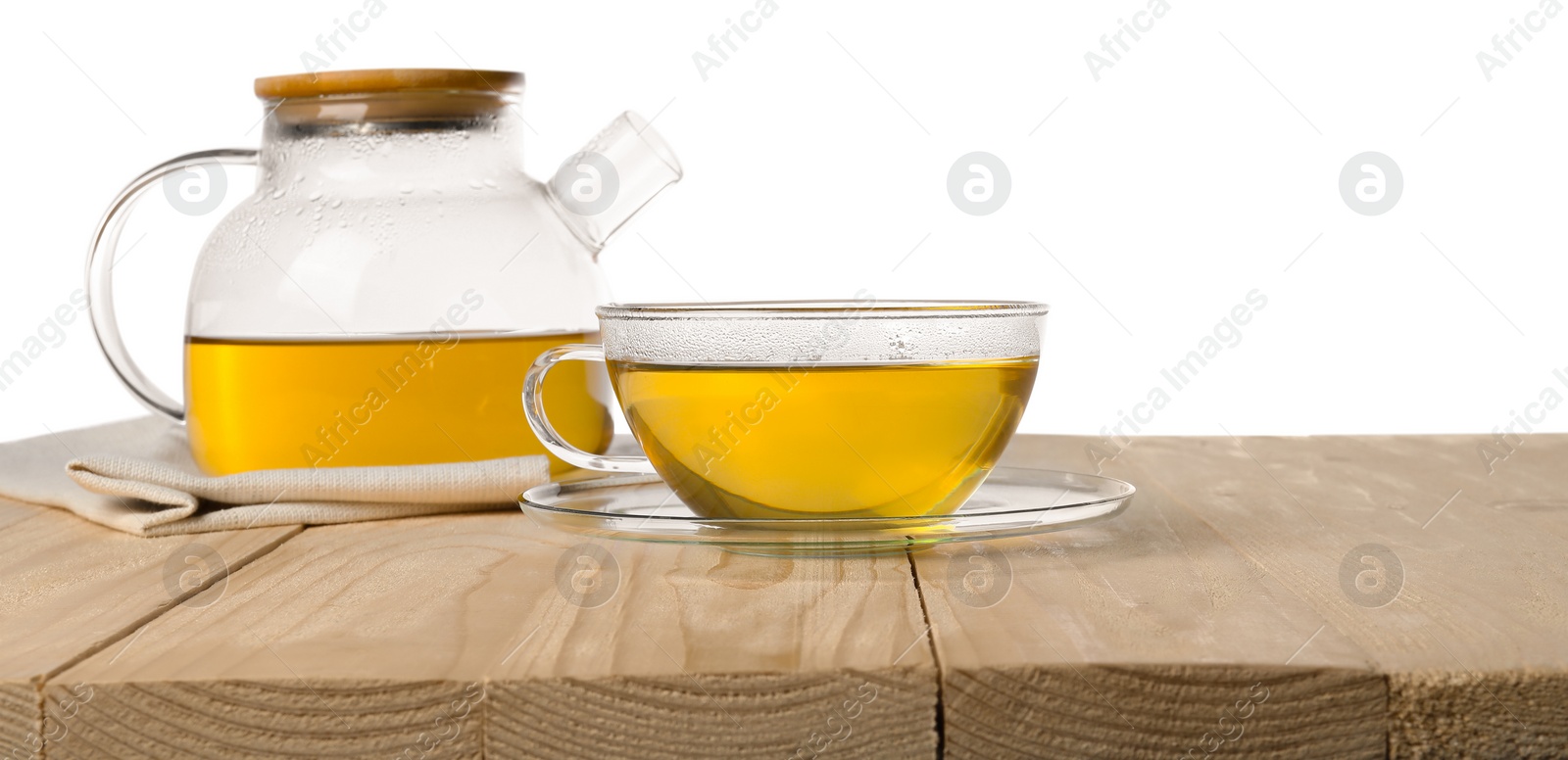 Photo of Refreshing green tea in cup and teapot on wooden table against white background