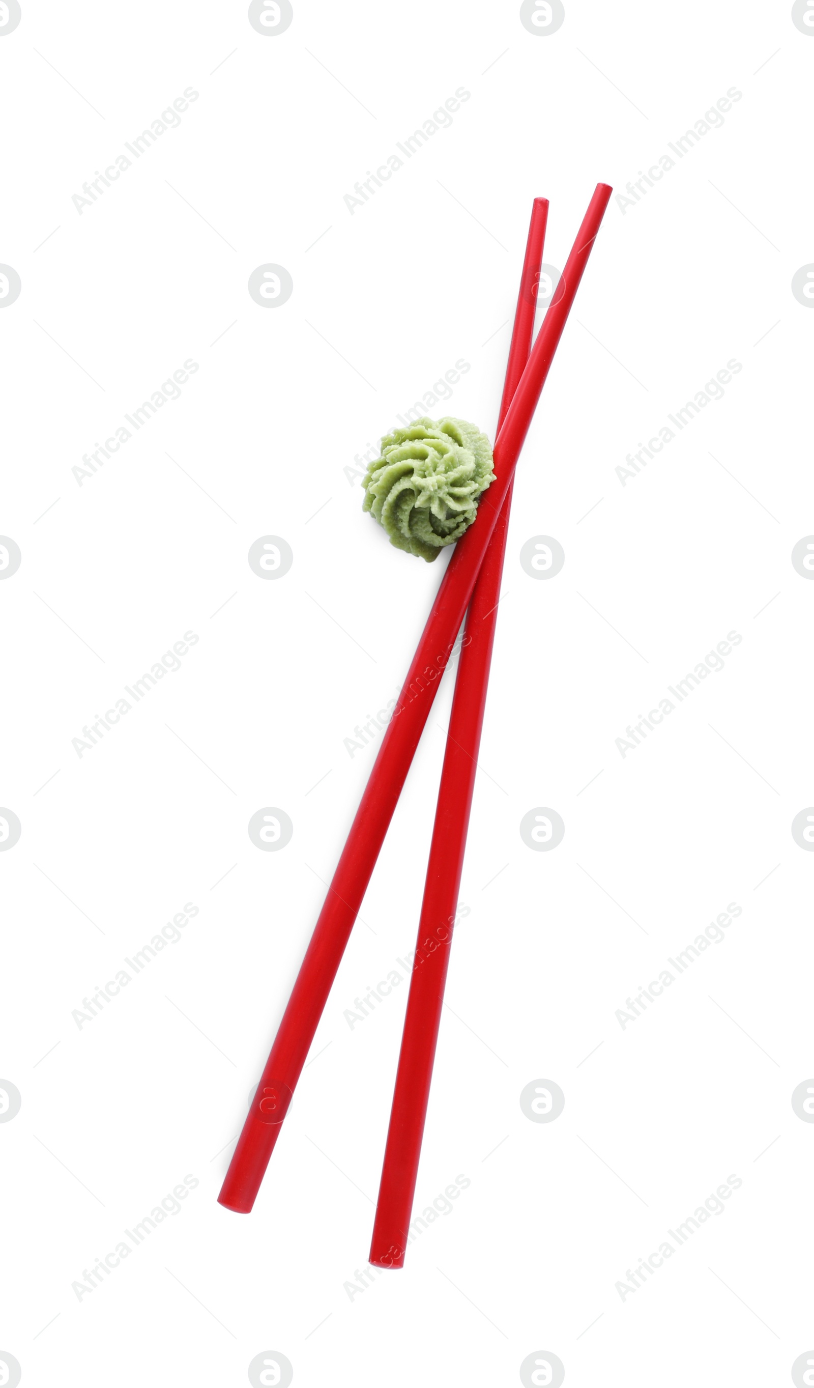 Photo of Swirl of wasabi paste and chopsticks on white background, top view