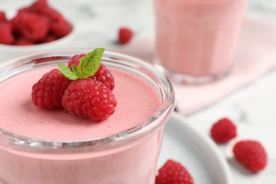 Photo of Glass of delicious raspberry mousse with mint, closeup. Space for text