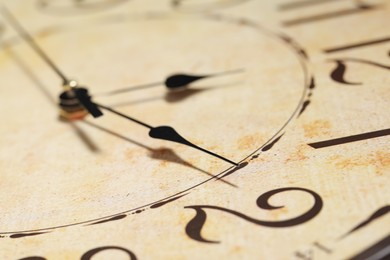 Photo of Closeup view of stylish beige clock. Interior element