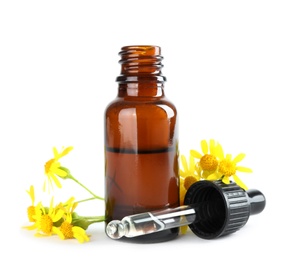 Photo of Bottle of herbal essential oil, pipette and flowers isolated on white