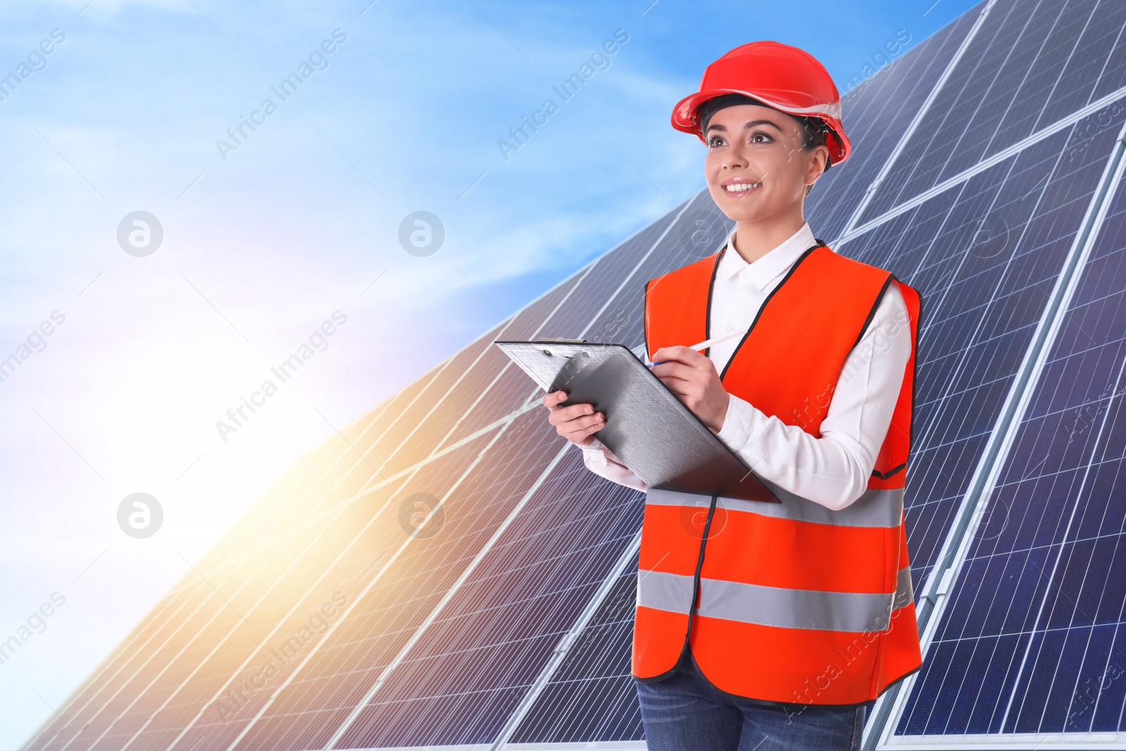 Image of Engineer near solar panels outdoors. Alternative energy source