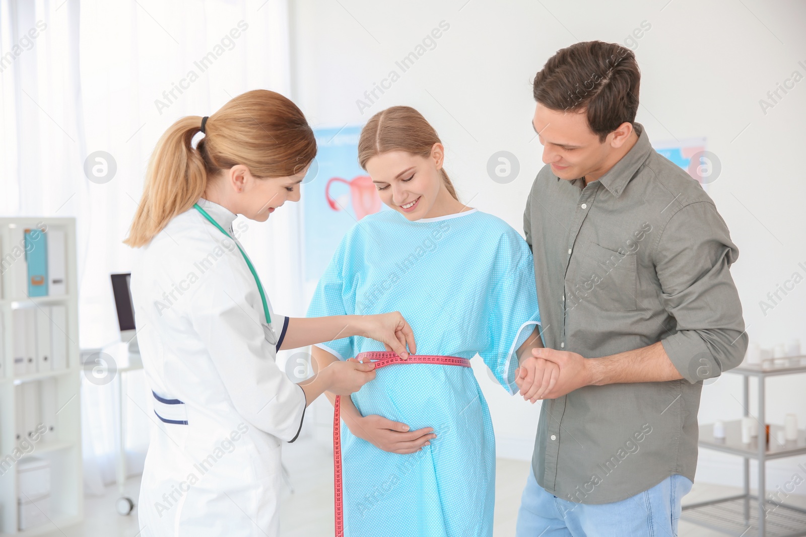 Photo of Gynecology consultation. Future parents with doctor in hospital