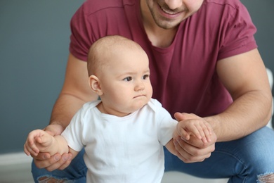 Photo of Cute little baby and father at home