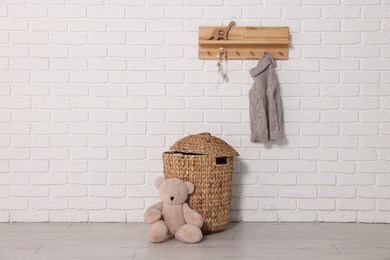 Photo of Beautiful children's room with white brick wall and toys. Interior design