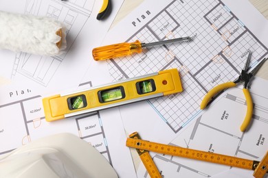 Photo of Flat lay composition with building level and other construction tools on white wooden table