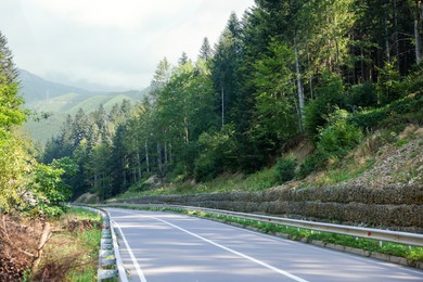 Empty asphalt road in mountains. Picturesque landscape