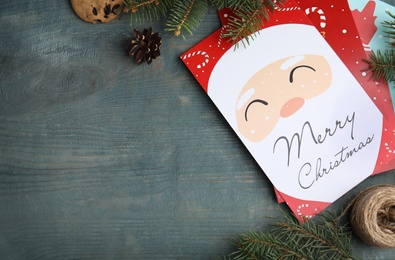 Flat lay composition with Christmas cards on light blue wooden background, space for text