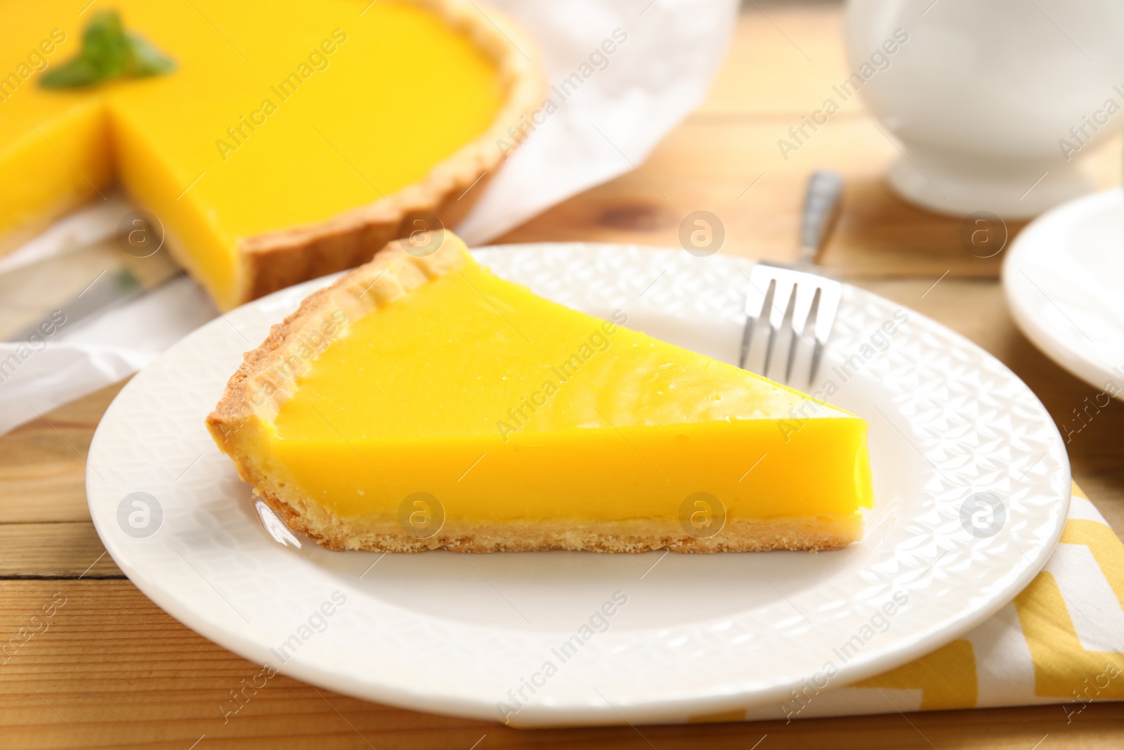 Photo of Delicious homemade lemon pie on wooden table