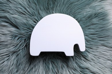 Photo of Elephant shaped child's night lamp on grey faux fur, top view