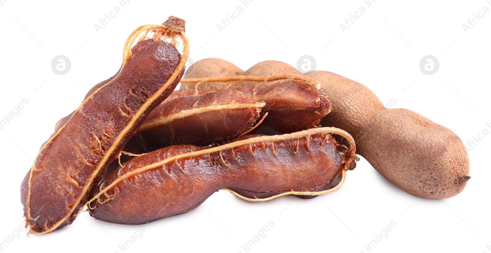 Photo of Delicious ripe tamarinds on white background. Exotic fruit