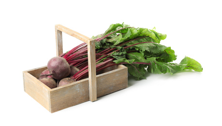 Photo of Raw ripe beets in wooden basket isolated on white