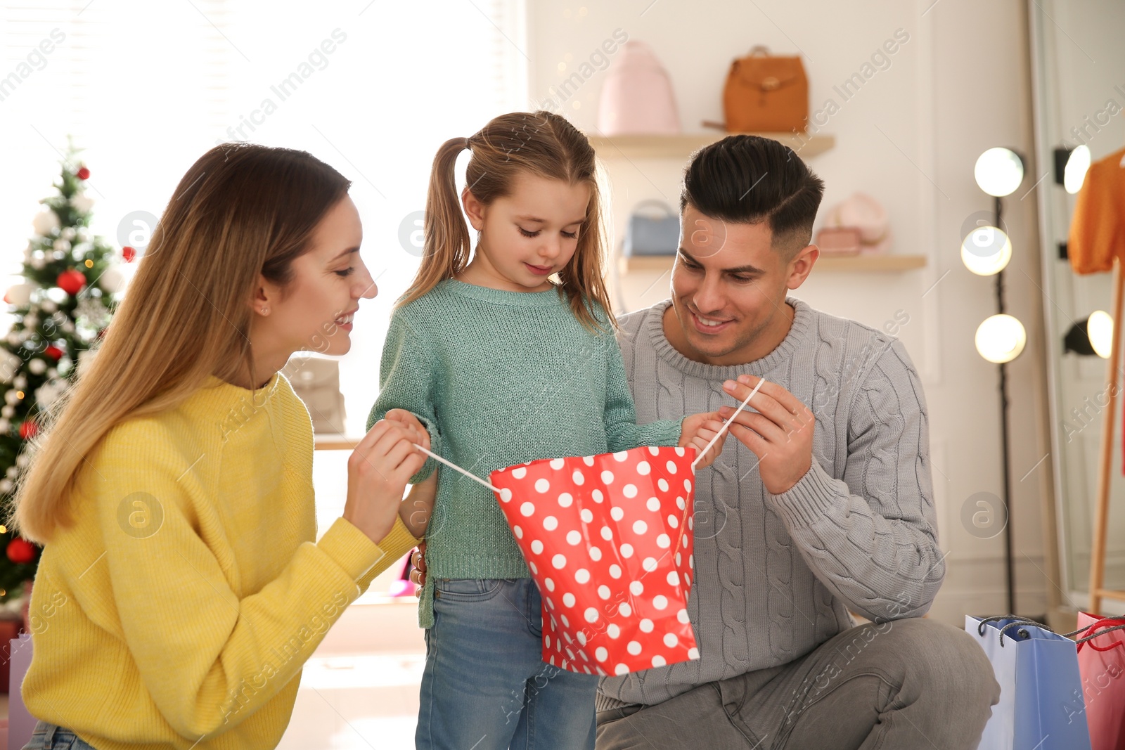 Photo of Happy family doing Christmas shopping in store