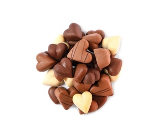 Delicious heart shaped chocolate candies on white background, top view