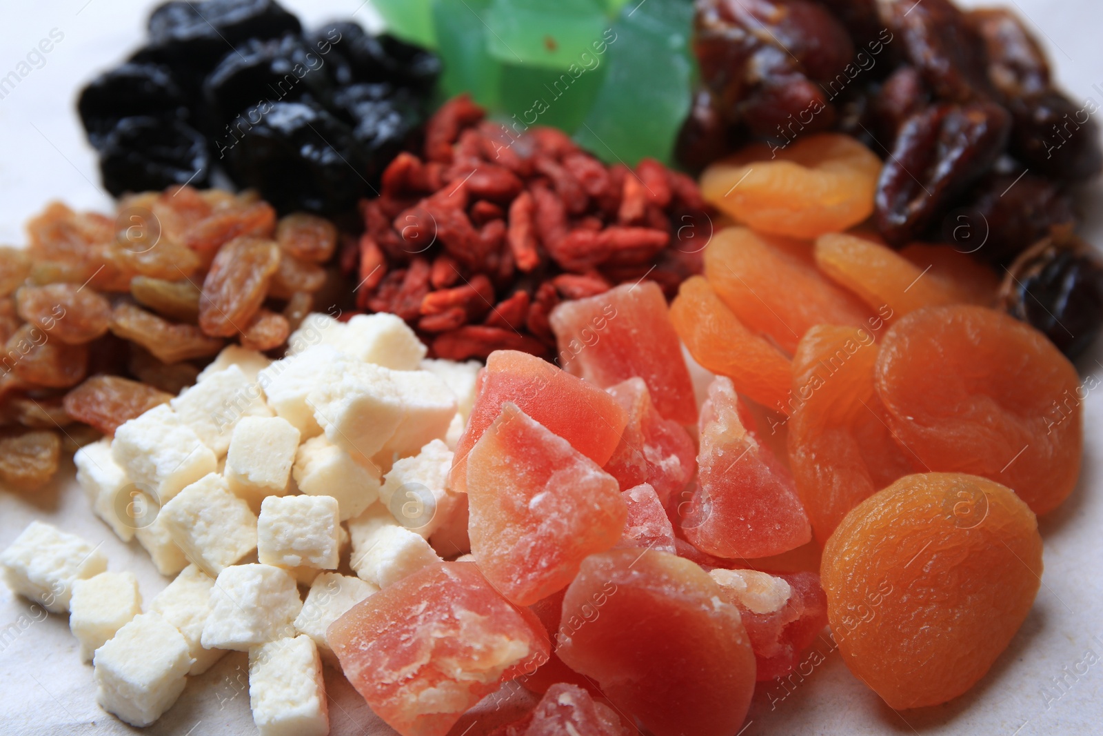 Photo of Pile of different dried fruits on white background, closeup