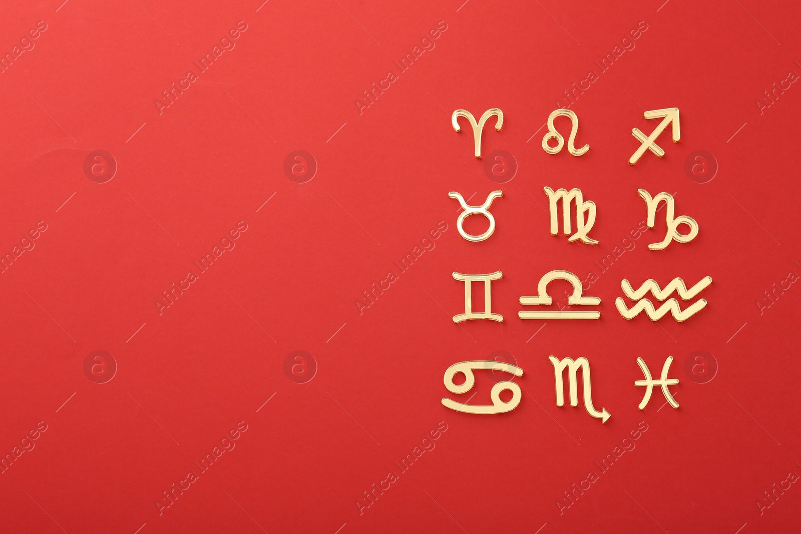 Photo of Zodiac signs on red background, flat lay. Space for text