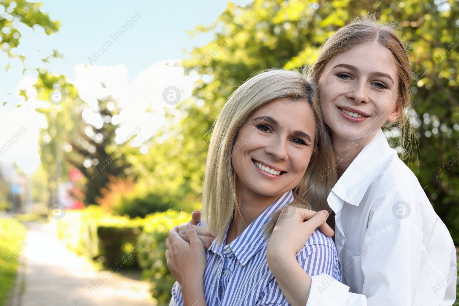 Photo of Happy mother with her daughter spending time together in park on sunny day