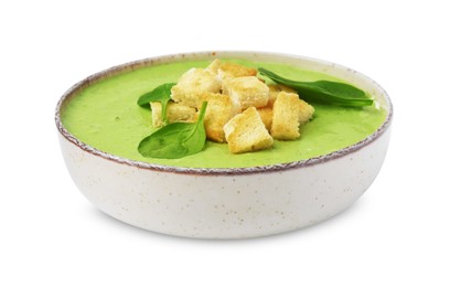 Delicious spinach cream soup with leaves and croutons in bowl isolated on white