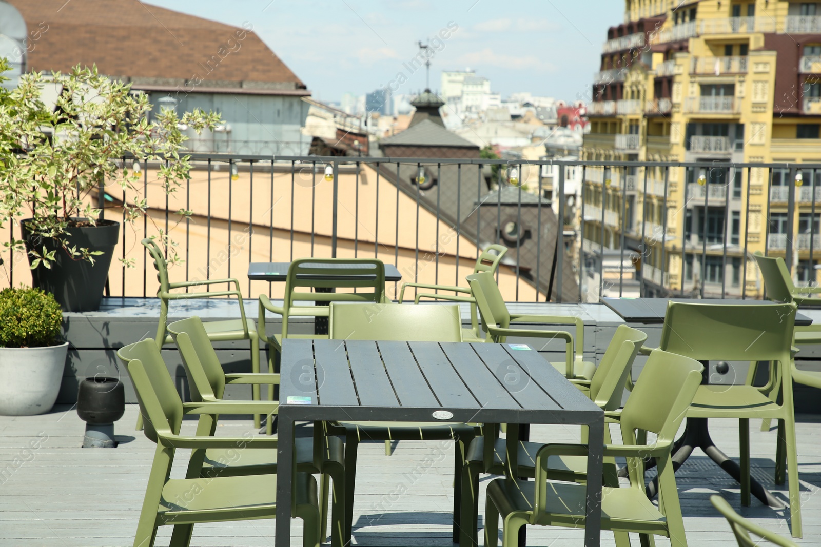 Photo of Observation area cafe. Tables and chairs on terrace against beautiful cityscape