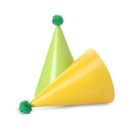 Photo of Two colorful party hats with pompoms isolated on white