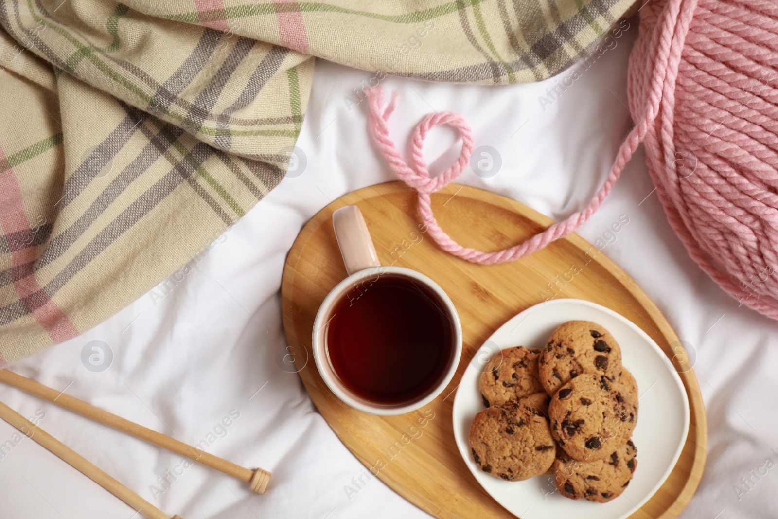 Photo of Flat lay composition with cup of hot winter drink on light fabric