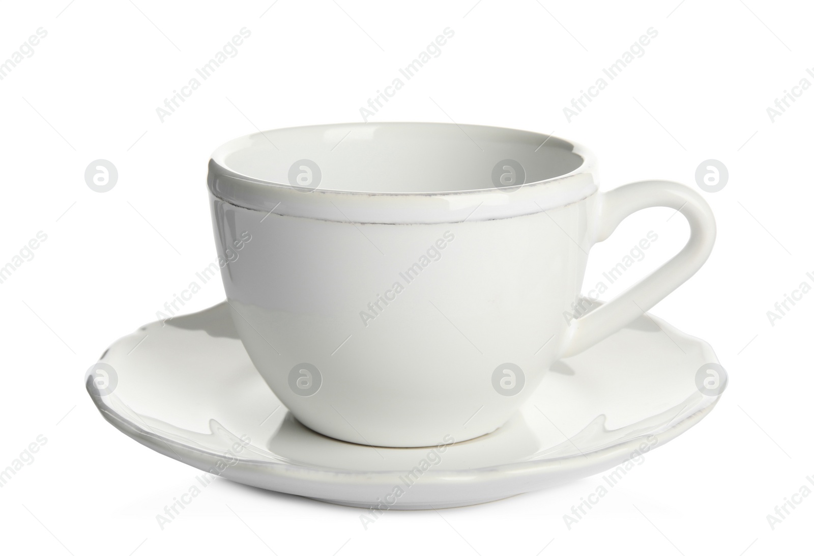 Photo of Empty ceramic cup and saucer isolated on white