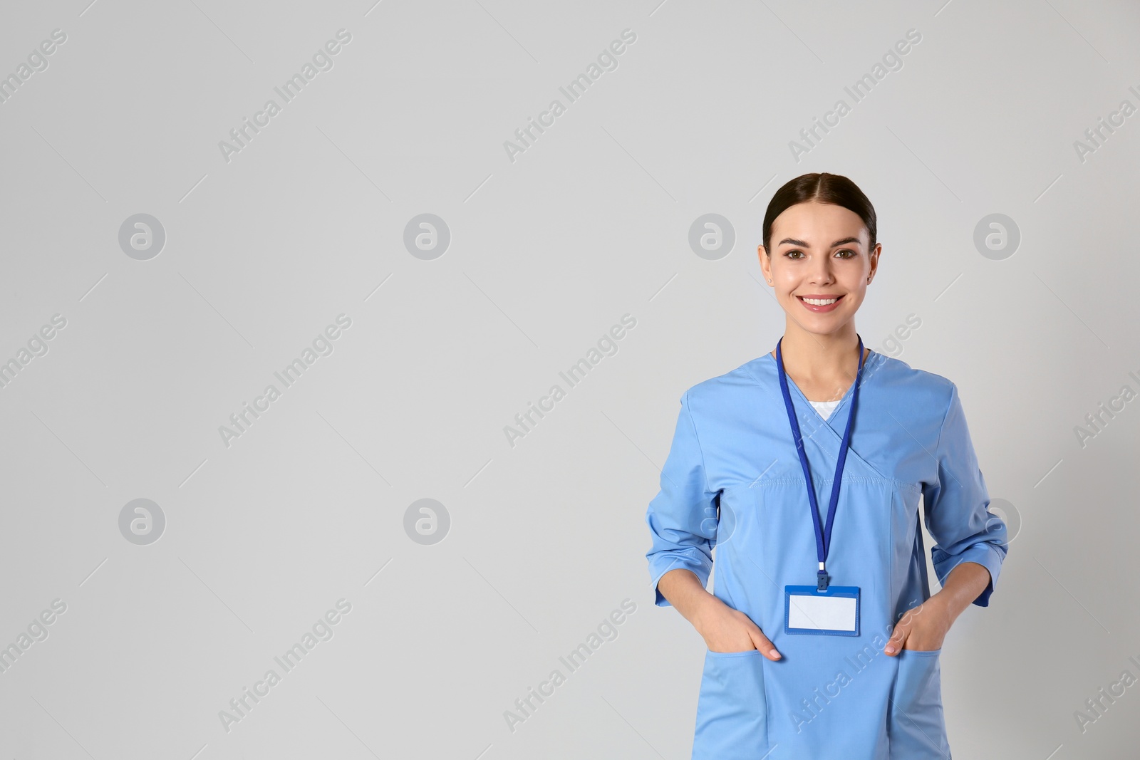 Photo of Portrait of young doctor against light background