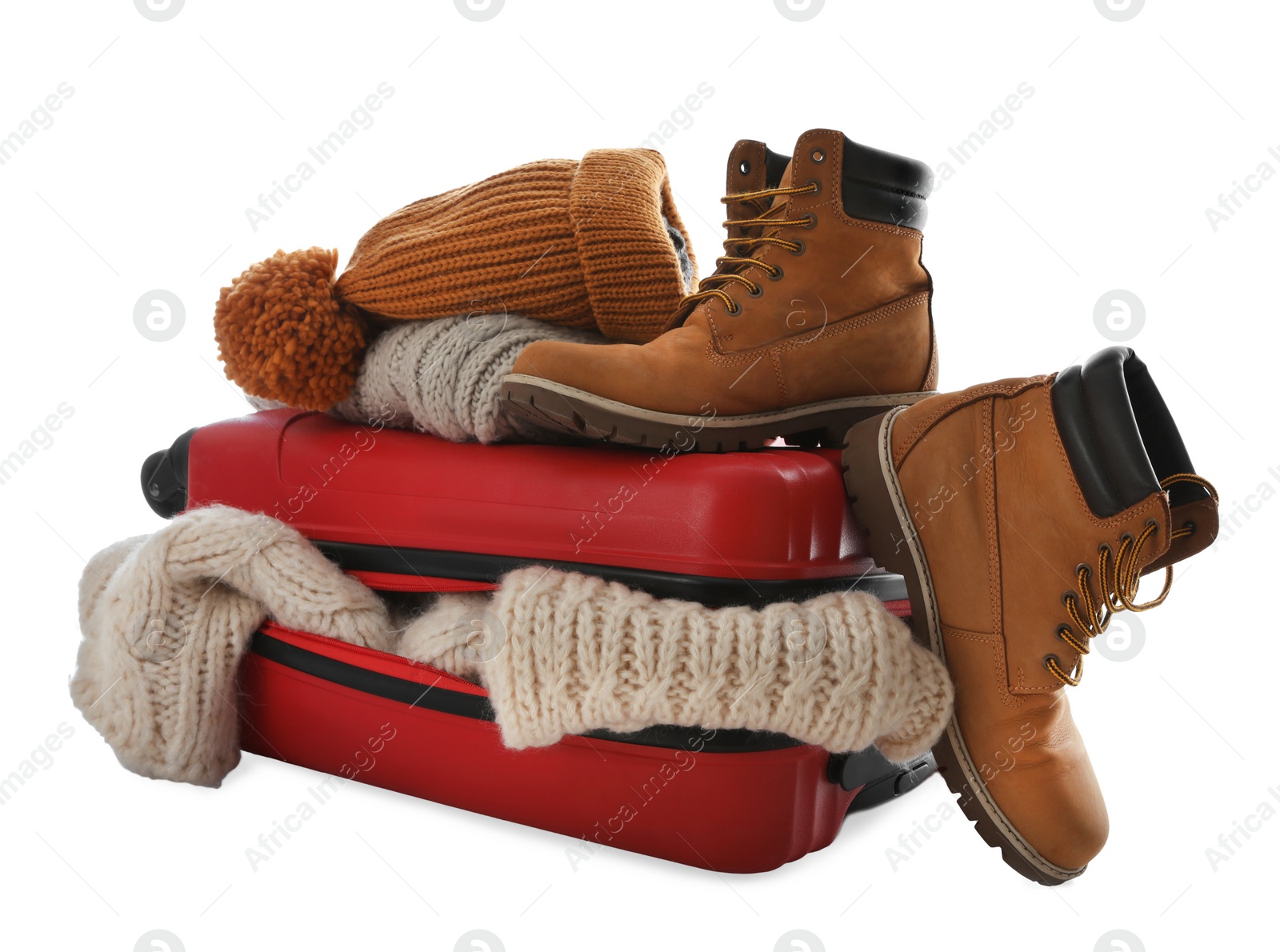 Photo of Suitcase with warm clothes isolated on white. Winter vacation