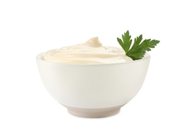 Photo of Bowl of tasty mayonnaise with parsley isolated on white