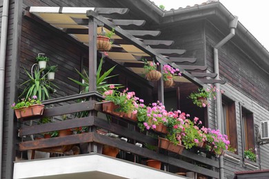 Exterior of beautiful residential building with balcony and flowers