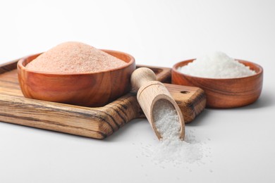 Photo of Different types of natural salt on white background