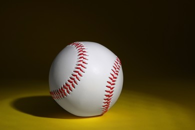 Photo of One baseball ball on dark background. Space for text