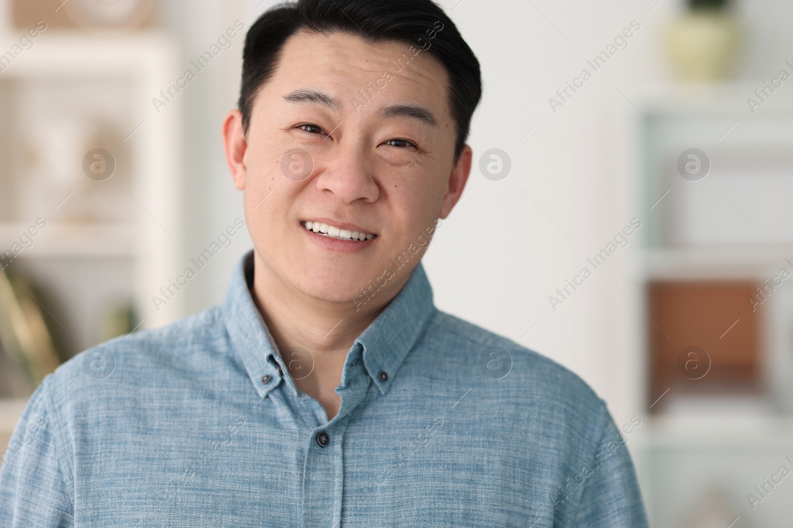 Photo of Portrait of smiling friendly businessman in office