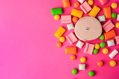 Many different chewing gums on pink background, flat lay. Space for text