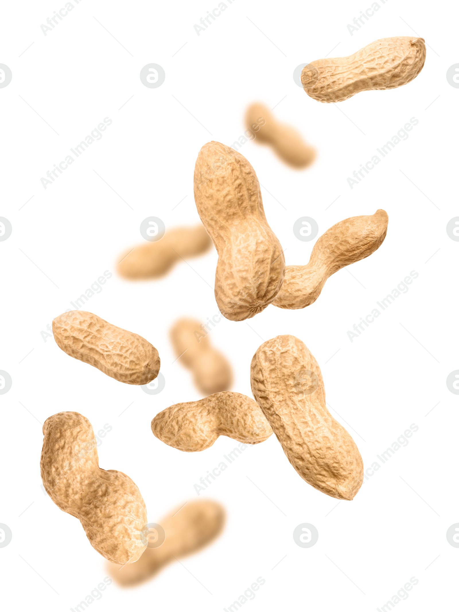 Image of Unpeeled peanuts in air on white background