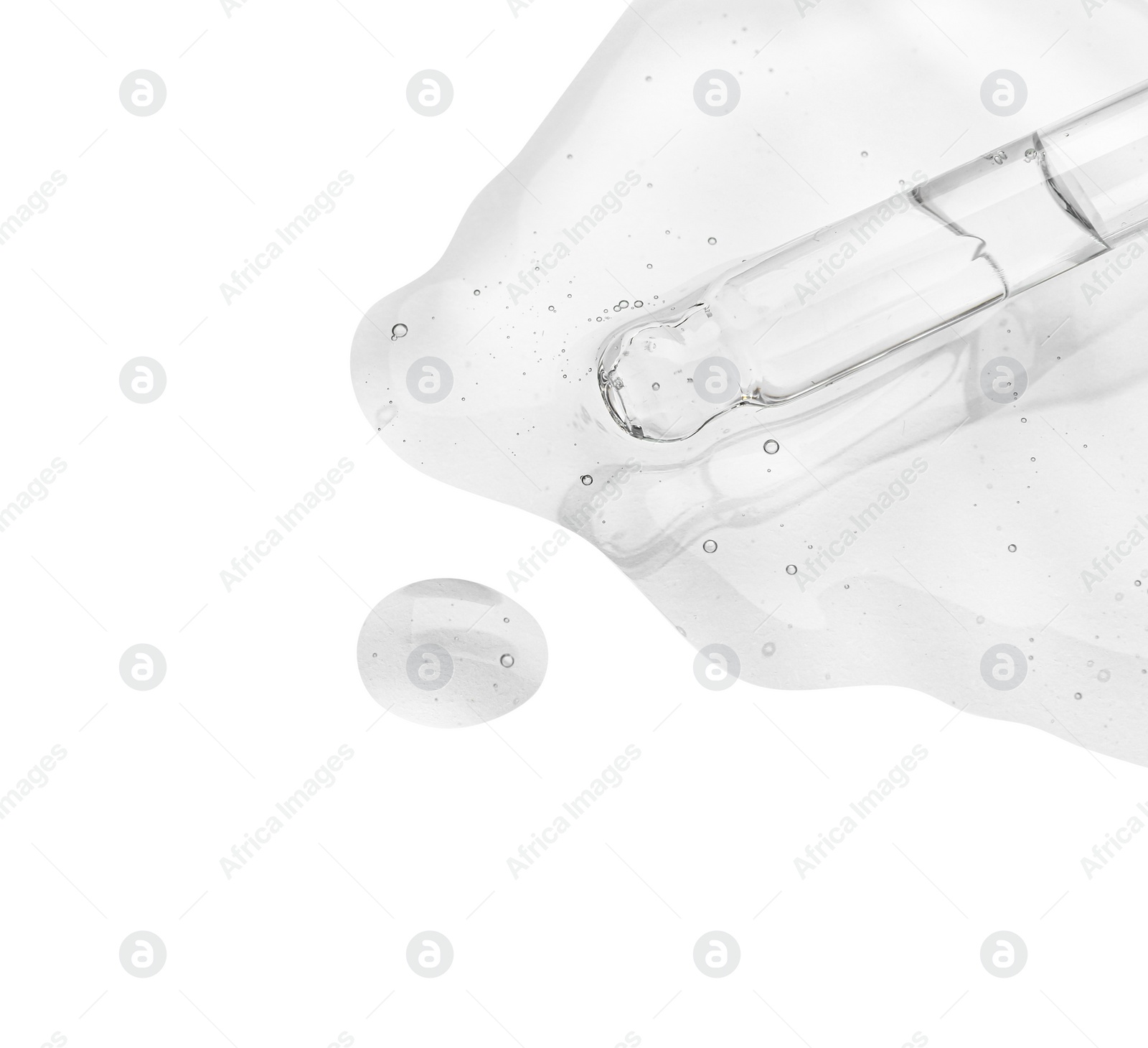 Photo of Dripping cosmetic oil from pipette onto light surface, closeup. Space for text