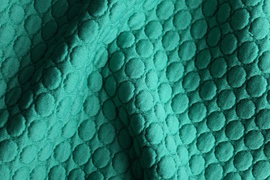 Textured turquoise fabric as background, closeup view